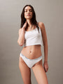 Calvin Klein MODERN LOGO Womens Thong Classic White front view modeled by a woman wearing a crop top.