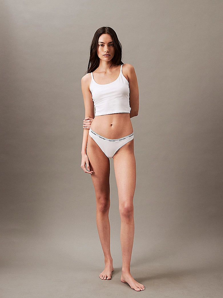 Calvin Klein MODERN LOGO Womens Thong Classic White, front view wearing white thong and tank top against a neutral background.