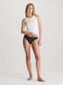 Calvin Klein LACE 3 Pack Bikini Womens Multicoloured Front view of model wearing low-rise black bikini with white tank top.