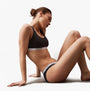 Calvin Klein LOW RISE 3 Pack Bikini Womens Multicoloured side view on model showcasing elastic waistband.