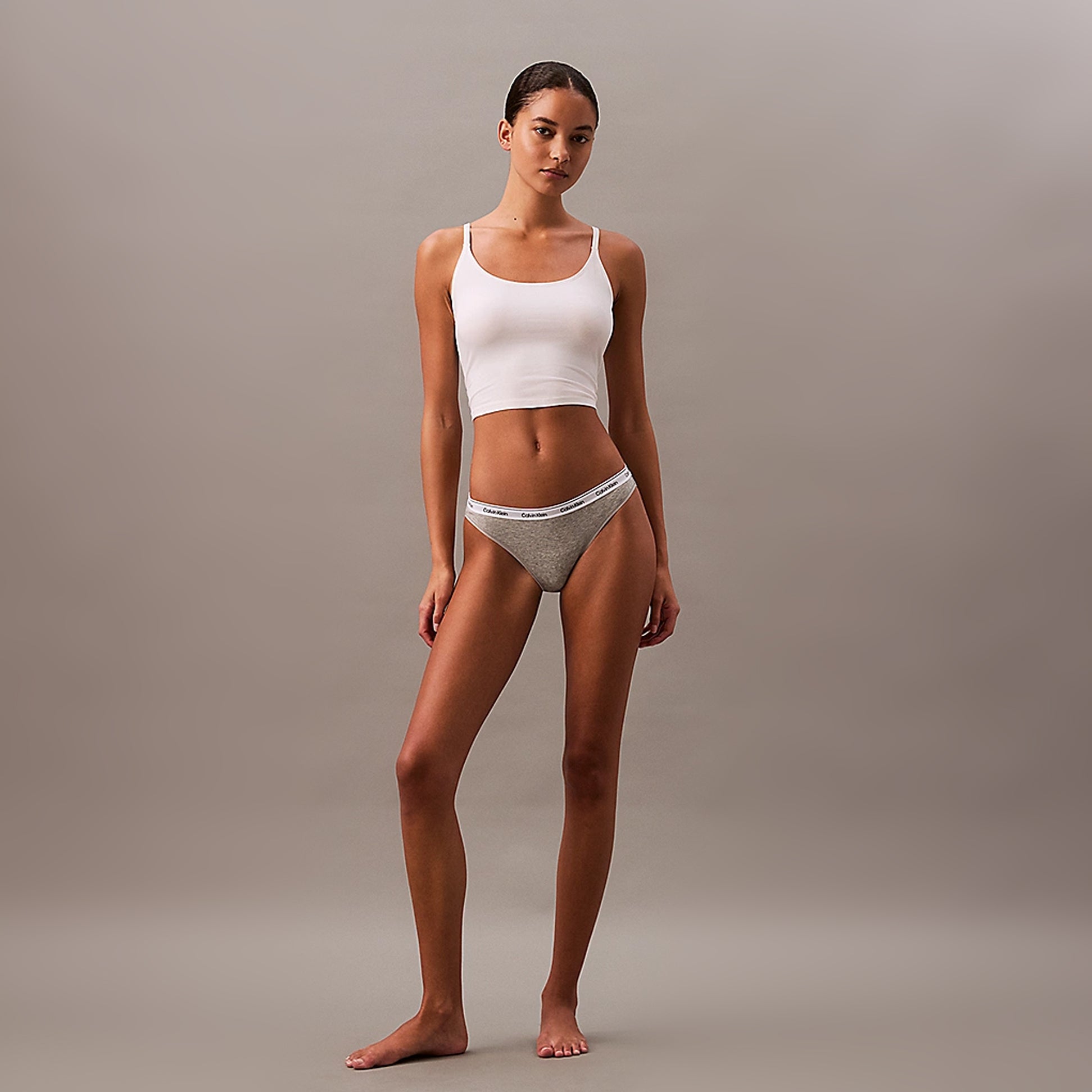 Calvin Klein MODERN LOGO Womens 3 Pack Low Rise Bikini Briefs Multicoloured front view, model wearing grey bikini briefs with white tank top.