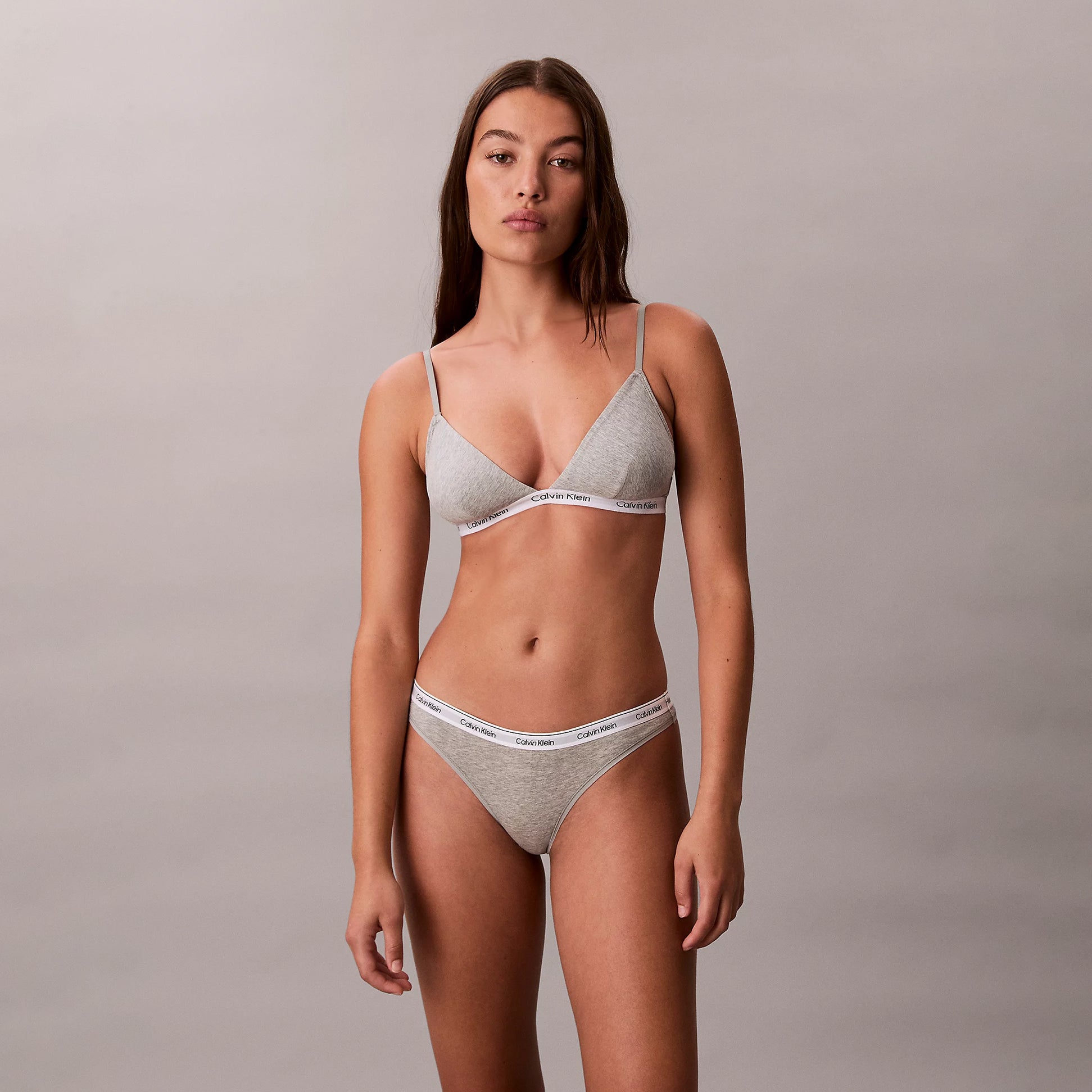 Calvin Klein Icon Logo Womens 3 Pack Thong Multi front view of model wearing gray thong and bralette set