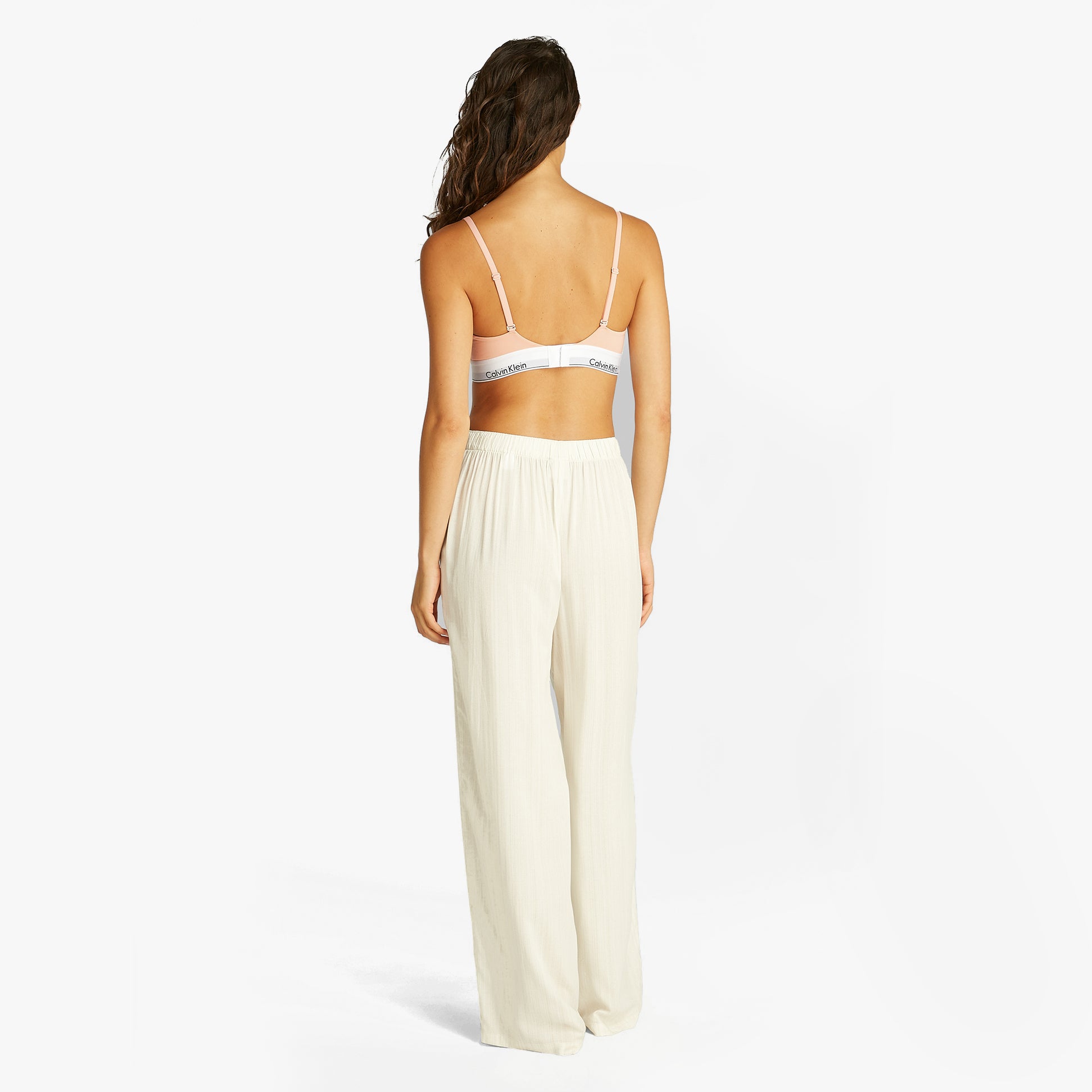 Calvin Klein ICON COTTON MODAL Womens Triangle Bra Melon Frenzy back view on model wearing light pants.