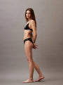 Calvin Klein MODERN LACE Lightly Lined Triangle Bra Womens Black side view on model, featuring geometric lace and adjustable straps.