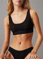 Calvin Klein UNLINED BRALETTE UB1 Womens Bra Black front view showcasing soft cups and adjustable straps.