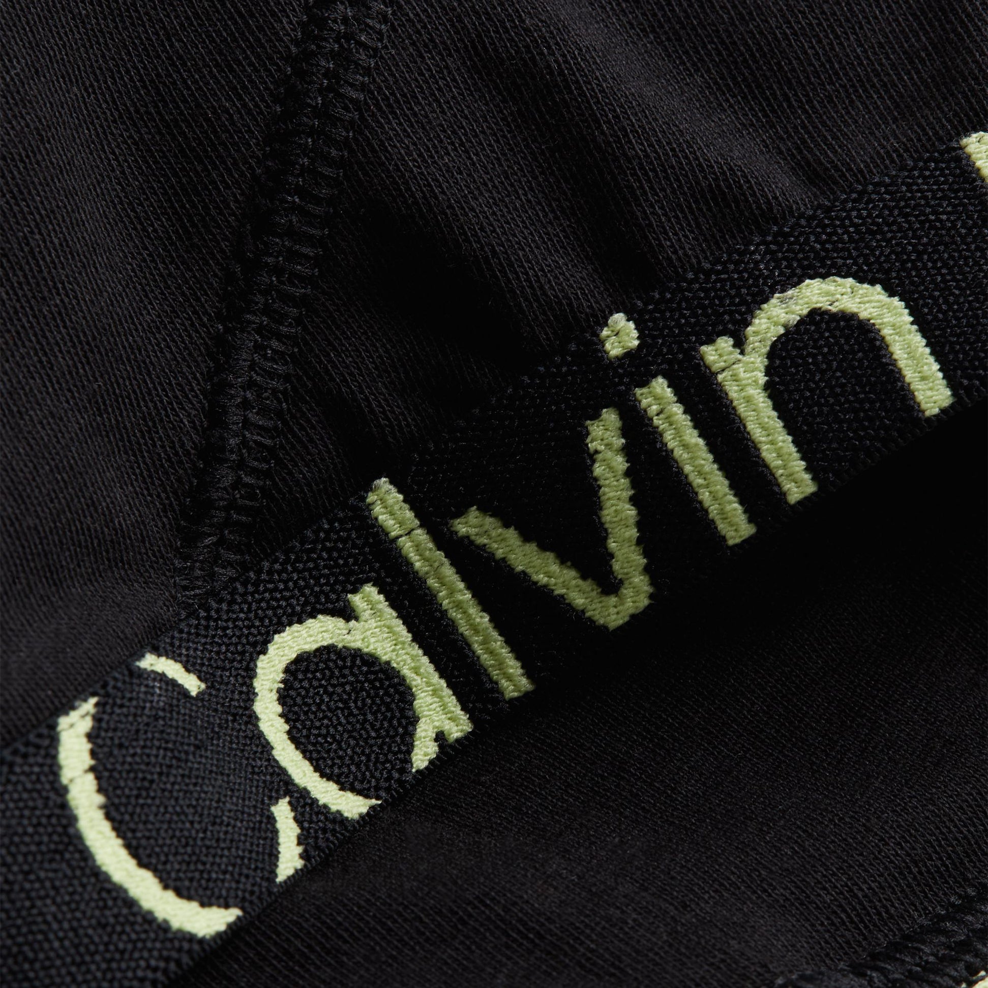 Calvin Klein UNLINED BRALETTE Womens Black Sunny Lime close-up detail view of bralette's strap and fabric.