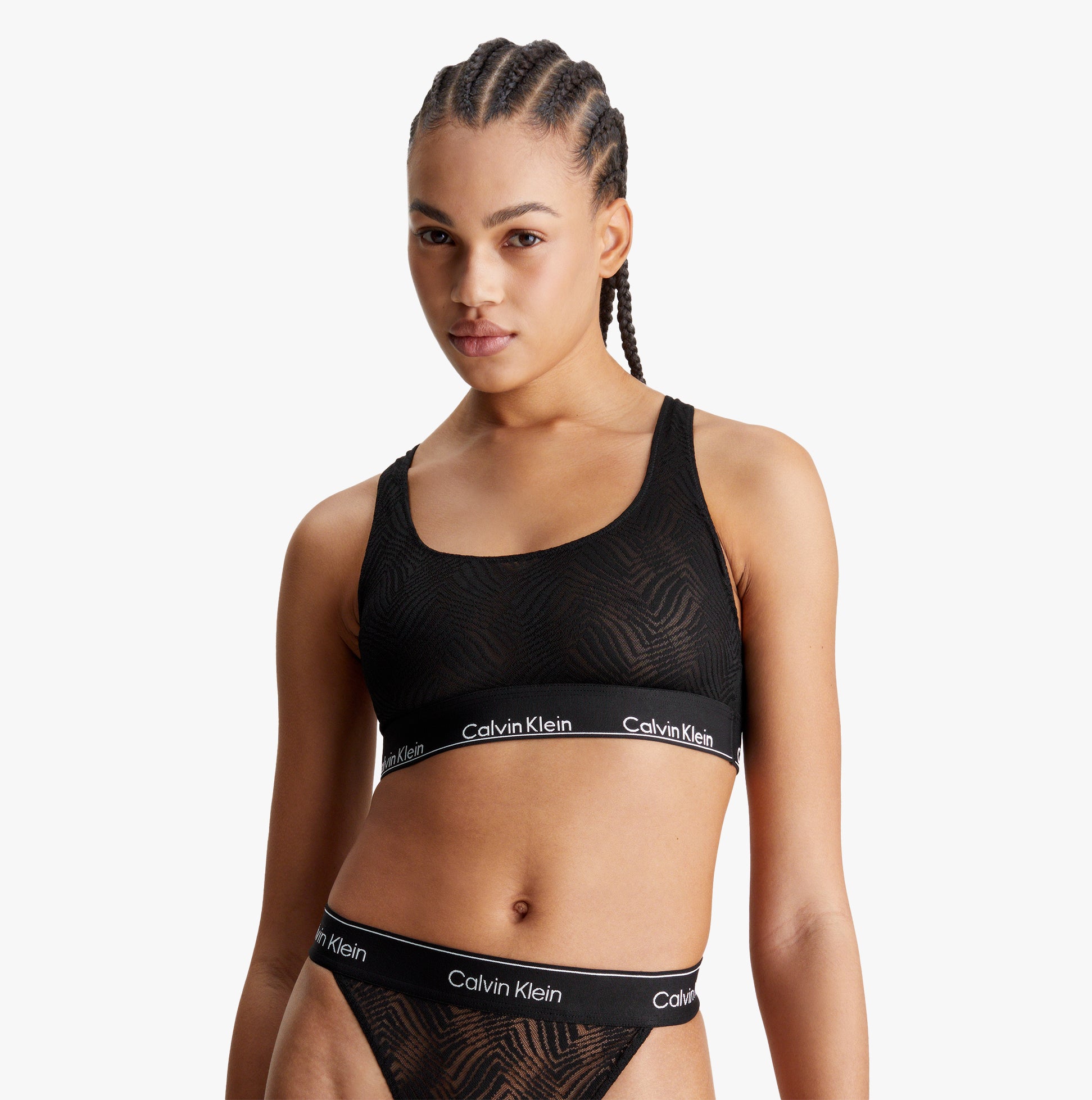 Calvin Klein LACE Unlined Bralette Womens Black front view, featuring semi-sheer graphic lace and Calvin Klein elastic underband.
