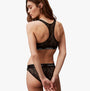 Calvin Klein LACE Unlined Bralette Womens Black, back view, featuring semi-sheer graphic lace and racerback design.