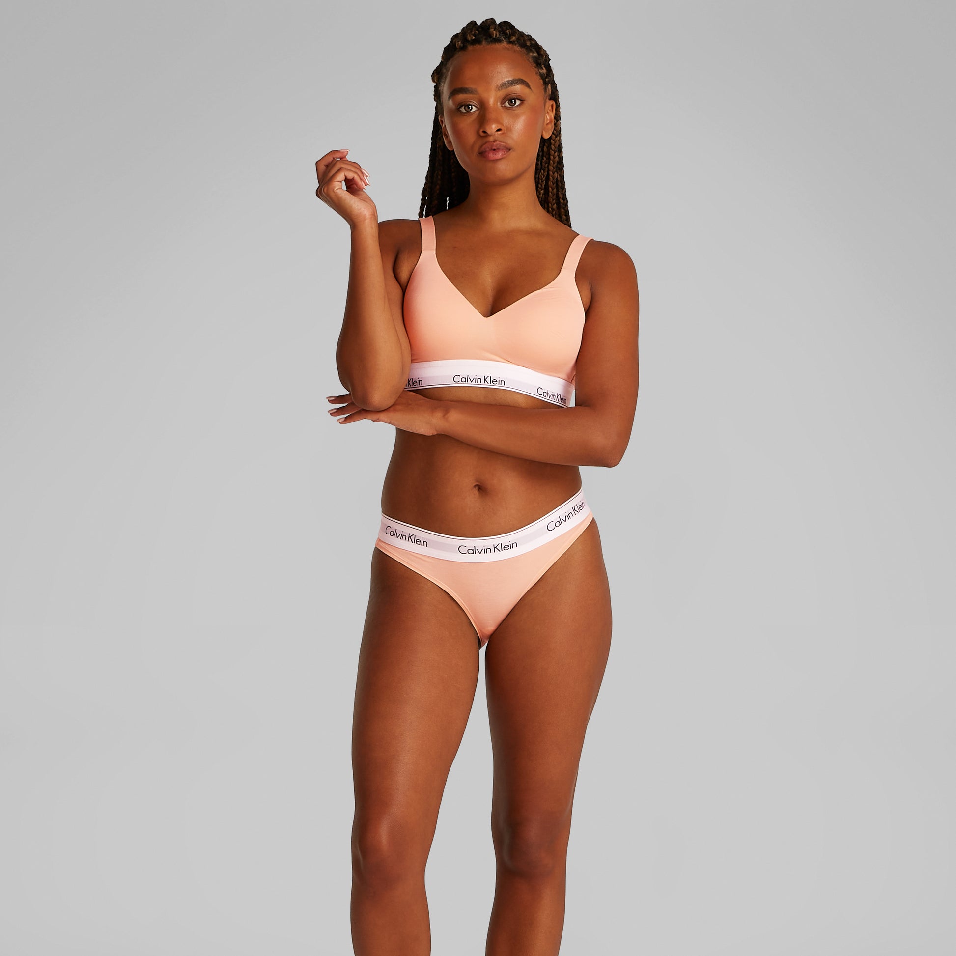Calvin Klein ICON COTTON Womens Lift Bralette Melon Frenzy front view worn by model, showcasing soft moulded cups and adjustable straps.