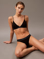Calvin Klein TONAL LOGO COTTON Womens Bikinis Black front view, model wearing bikini set with logo detailing.