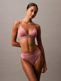 Calvin Klein TONAL LOGO COTTON Womens Thong Red Grape W/ Apple Butter Logo front view model wearing pink lingerie set