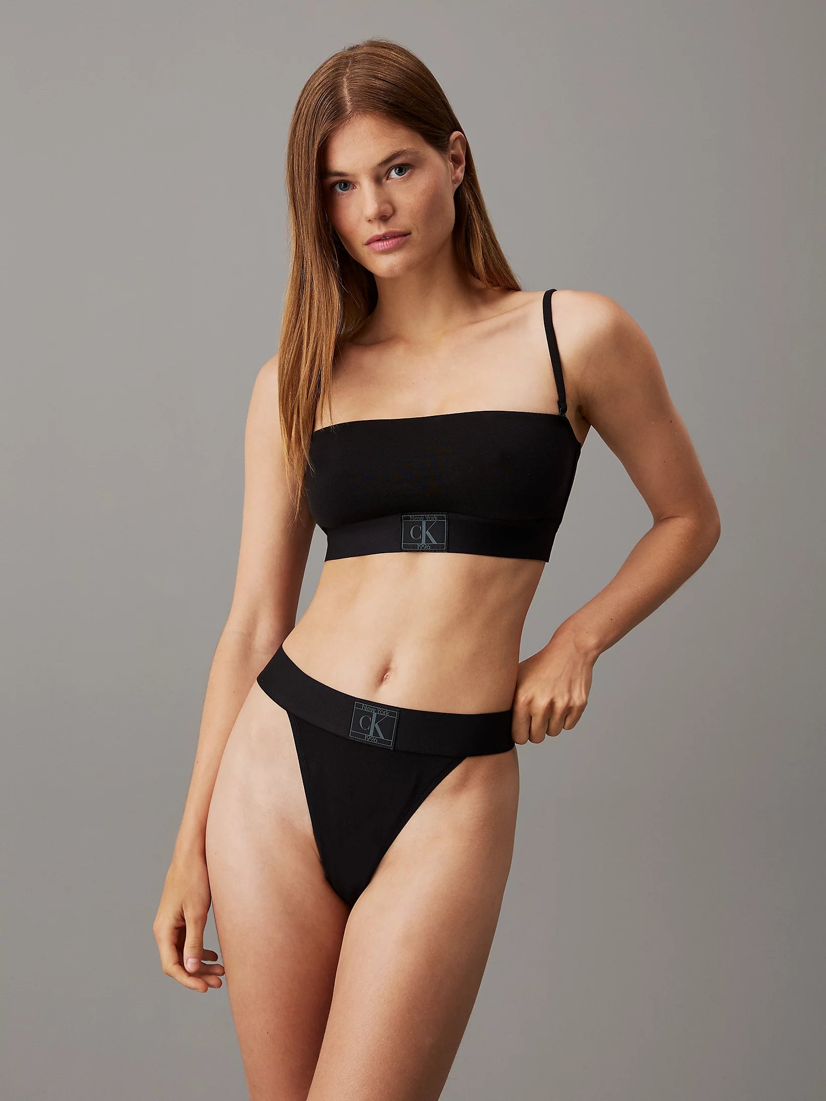 Calvin Klein CK ESTABLISHED Womens Unlined Bralette Black front view on model with matching black underwear.