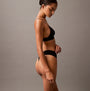 Calvin Klein CK ESTABLISHED Womens Thong Black side view on model, showcasing soft fabric and thong design.