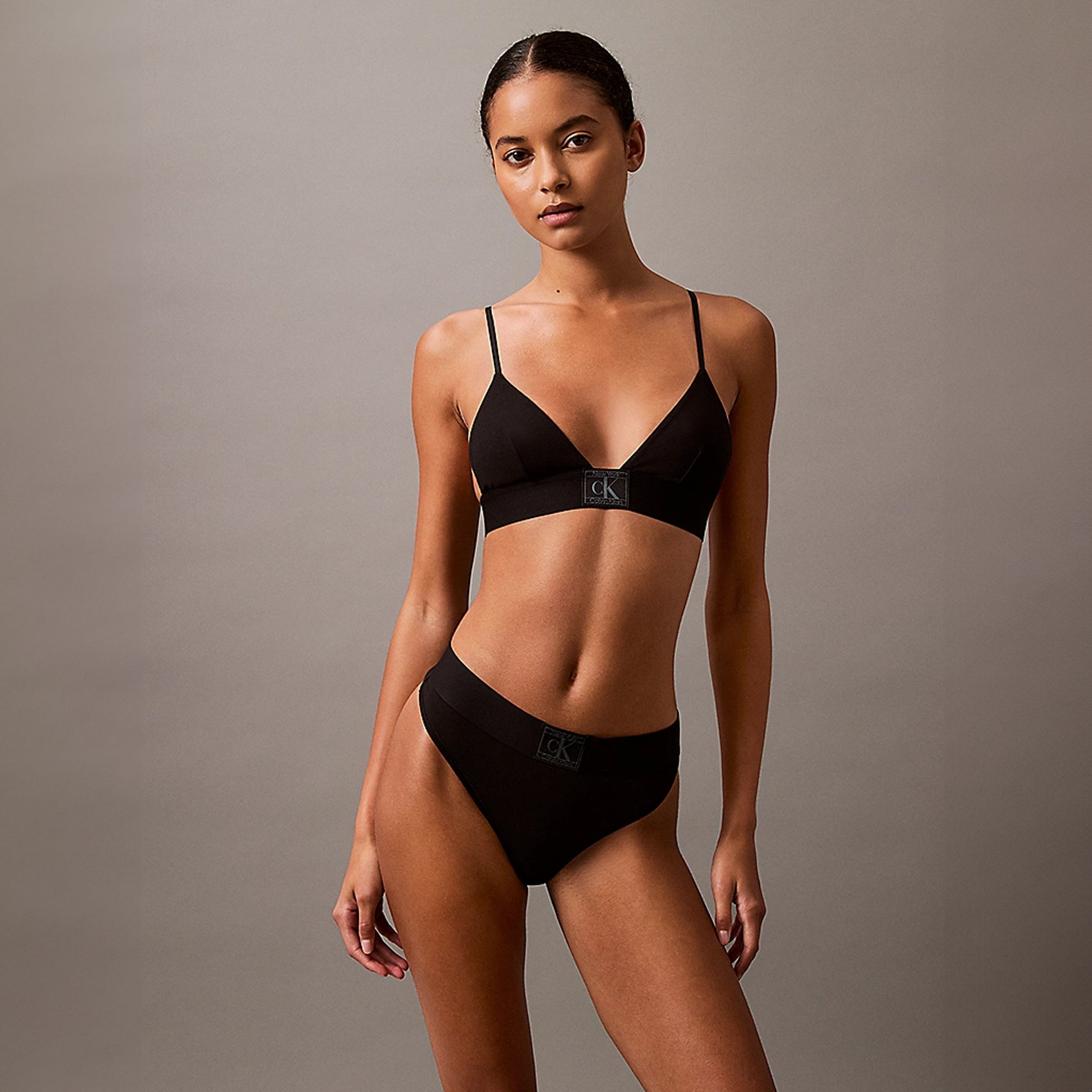 Calvin Klein CK ESTABLISHED Womens Thong Black front view, model wearing black thong and bralette.