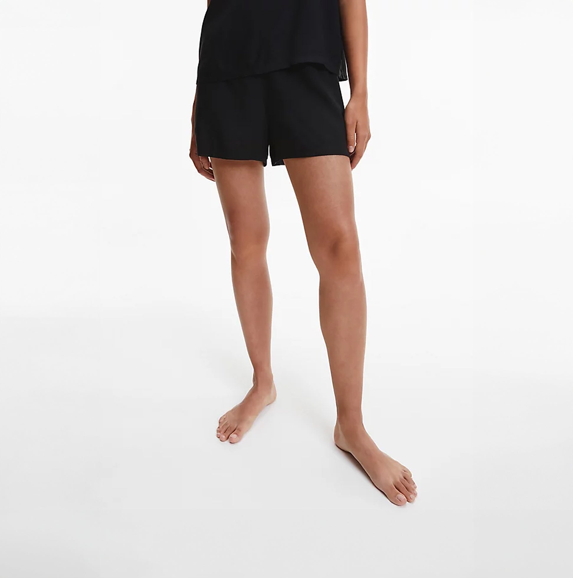Calvin Klein WOVEN VISCOSE Sleep Short Womens Black front view showing elasticated waistband and slit pockets.