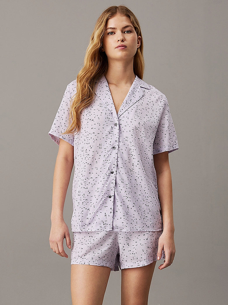 Calvin Klein WOVEN VISCOSE Pyjama Set Womens Scatter Logo Print/Lavender Blue front view featuring short sleeves and button details.