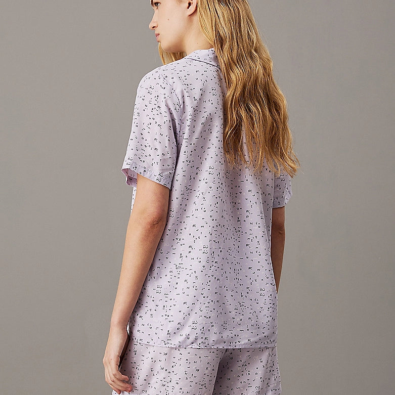 Calvin Klein WOVEN VISCOSE Pyjama Set Womens Scatter Logo Print/Lavender Blue rear view showcasing short sleeves and elasticated waist.