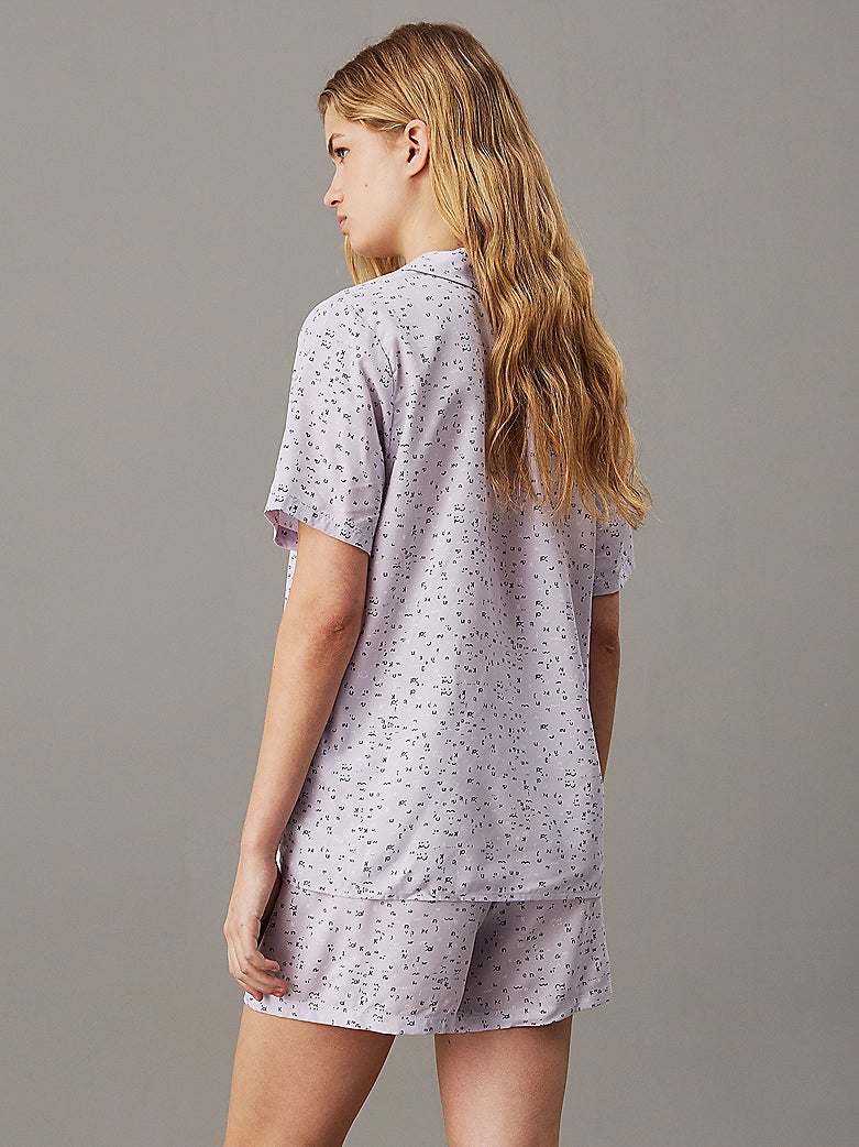 Calvin Klein WOVEN VISCOSE Pyjama Set Womens Scatter Logo Print/Lavender Blue rear view showcasing short sleeves and elasticated waist.