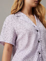 Calvin Klein WOVEN VISCOSE Pyjama Set Womens Scatter Logo Print/Lavender Blue side view, showcasing short sleeves and classic collar design.