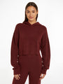 Calvin Klein Womens Hooded Sweater Tawny Port Red front view on model, showcasing the soft fabric and relaxed fit.