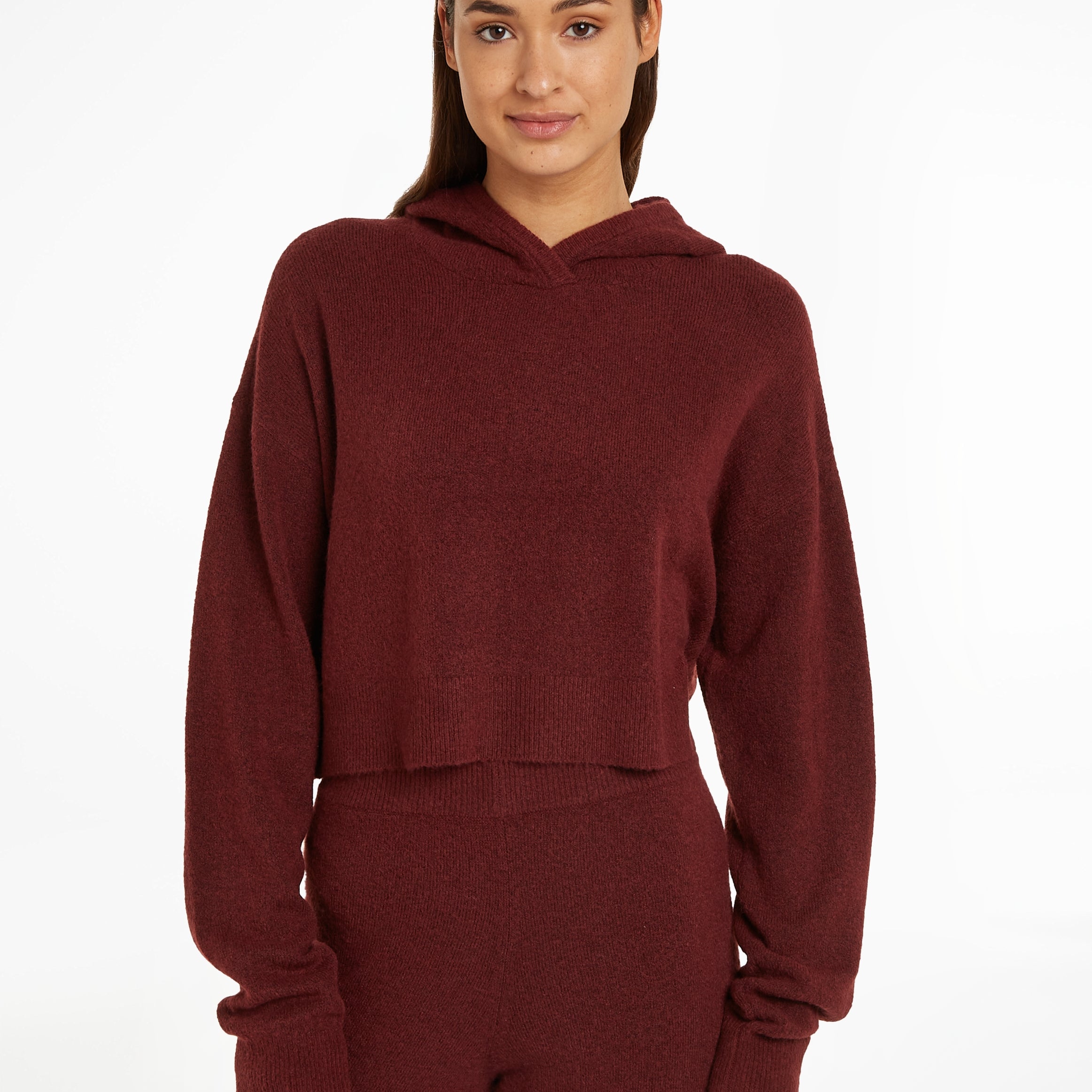 Calvin Klein Womens Hooded Sweater Tawny Port Red front view on model, showcasing the soft fabric and relaxed fit.