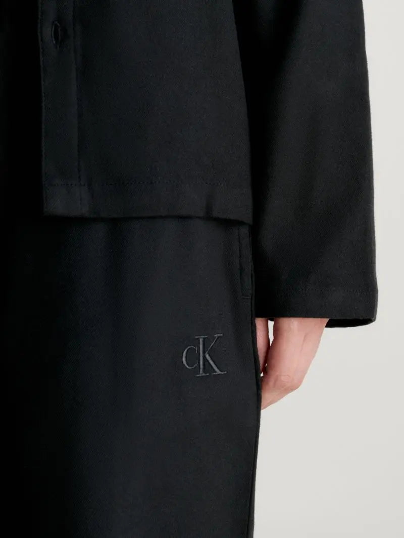 Calvin Klein L/S PANT SET UB1 Womens Pyjamas Black close-up detail view featuring logo embroidery and fabric texture.