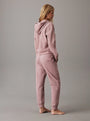 Calvin Klein TONAL LOGO LOUNGE Womens Hoodie Sand Trap, back view model wearing comfortable hoodie in sand trap color.