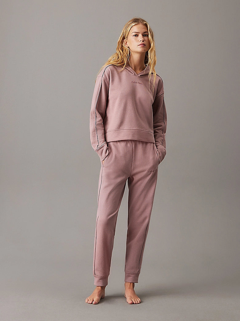 Calvin Klein TONAL LOGO LOUNGE Womens Hoodie Sand Trap front view on model, showcasing cozy design and comfortable fit.