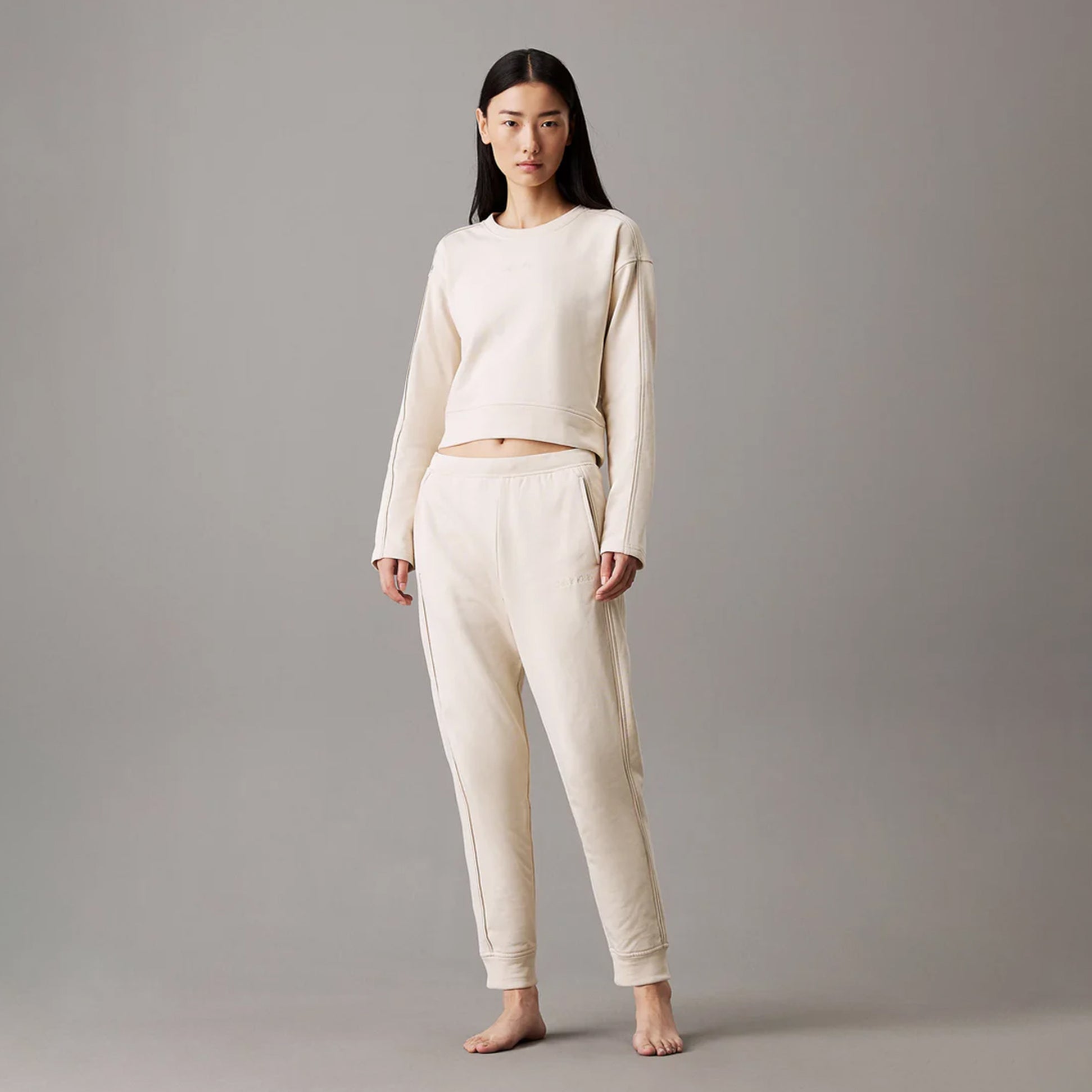 Calvin Klein TONAL LOGO LOUNGE Womens Joggers Sandshell front view with model wearing comfortable cotton joggers.