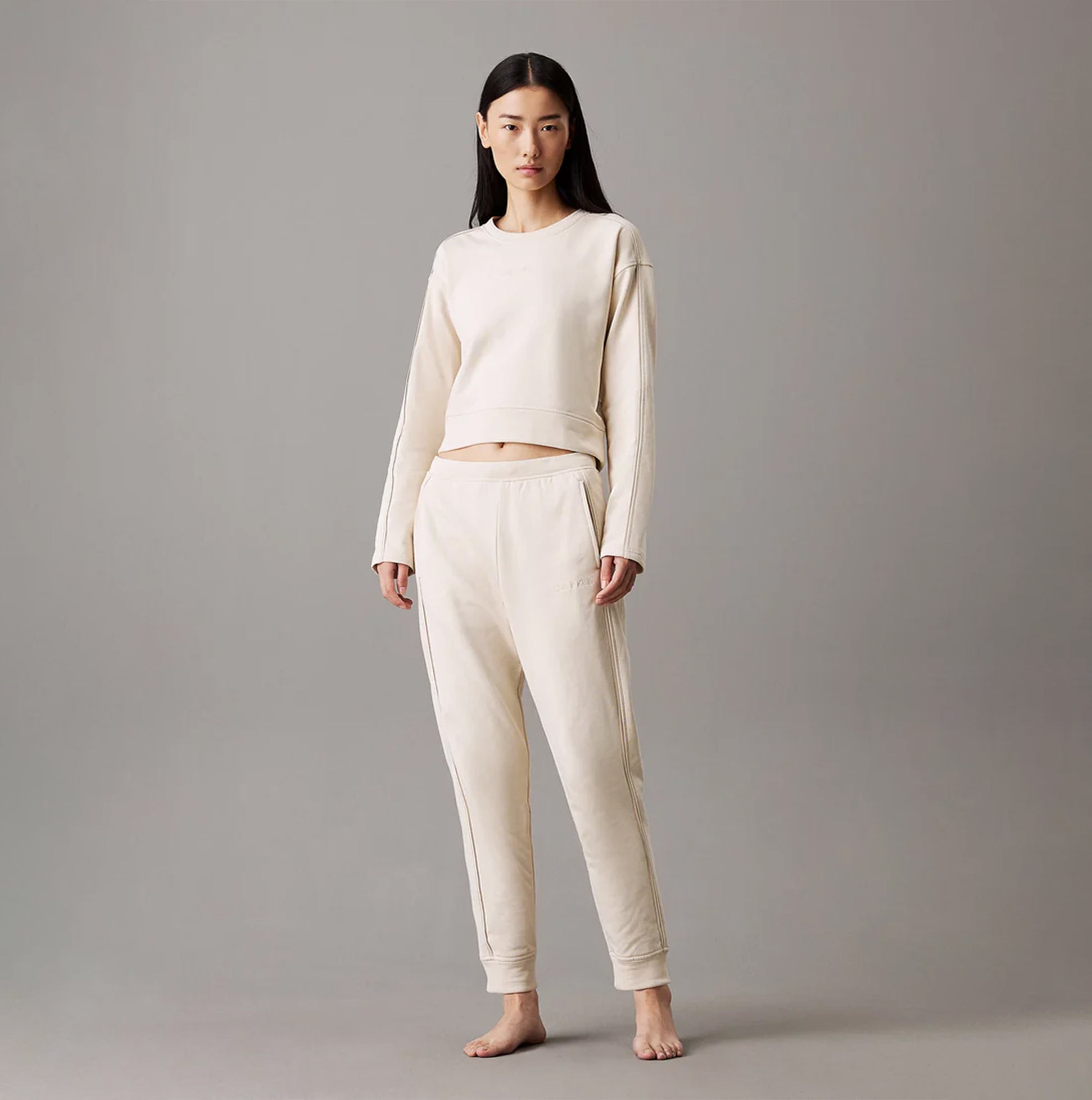 Calvin Klein TONAL LOGO LOUNGE Womens Joggers Sandshell front view with model wearing comfortable cotton joggers.
