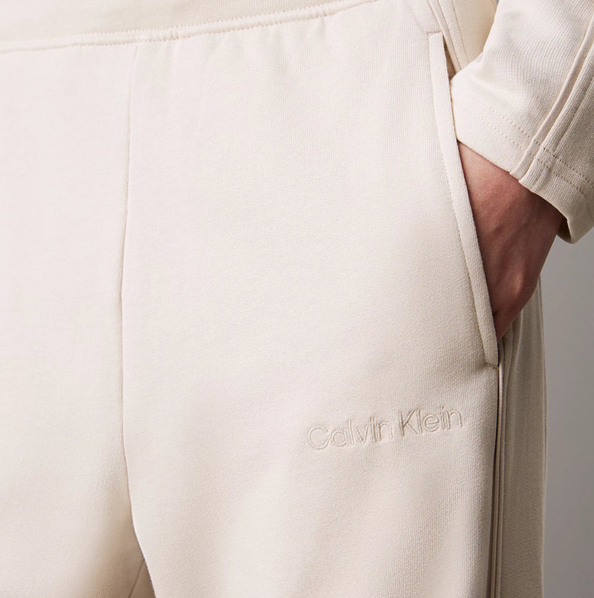Calvin Klein TONAL LOGO LOUNGE Womens Joggers Sandshell detail view showcasing logo and fabric texture.