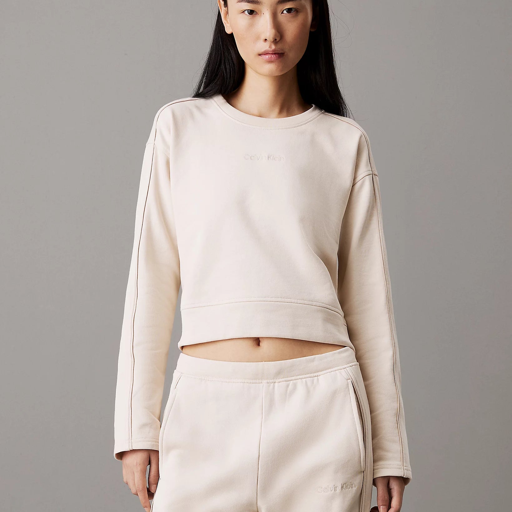 Calvin Klein COTTON FLEECE Womens Crew Pullover Sandshell front view worn by model with matching pants.