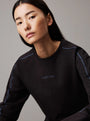 Calvin Klein COTTON FLEECE Womens Crew Pullover Black detail view featuring model wearing black sweatshirt with logo.