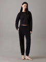 Calvin Klein COTTON FLEECE Womens Crew Pullover Black front view model wearing paired with black joggers.