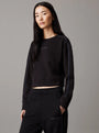 Calvin Klein COTTON FLEECE Womens Crew Pullover Black front view on model with long sleeves in black.