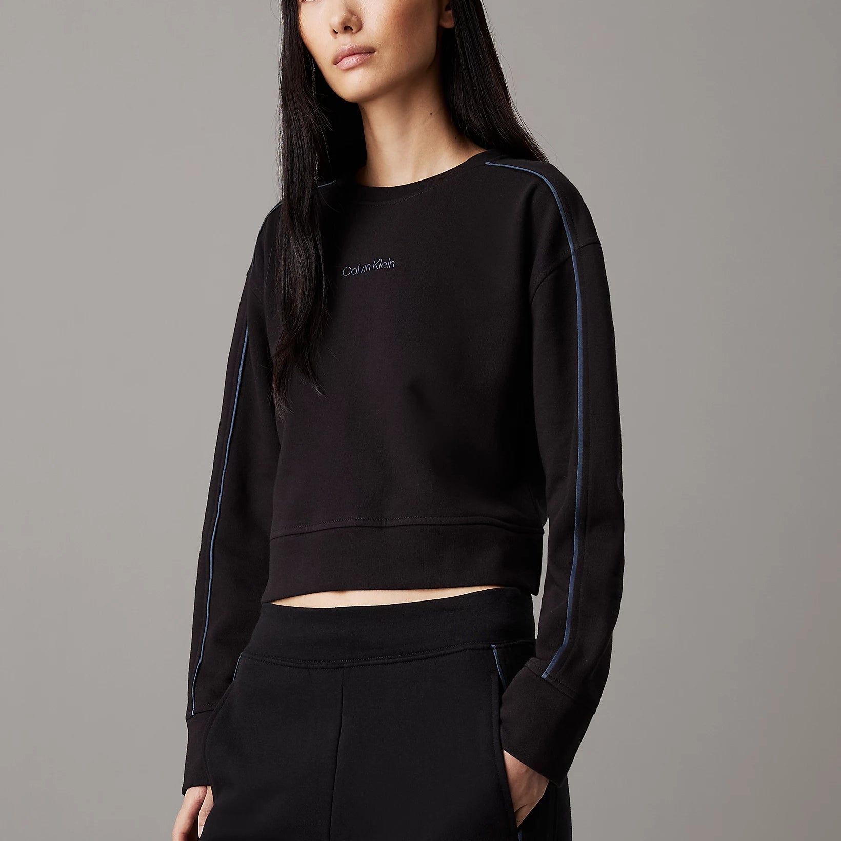 Calvin Klein COTTON FLEECE Womens Crew Pullover Black front view on model with long sleeves in black.