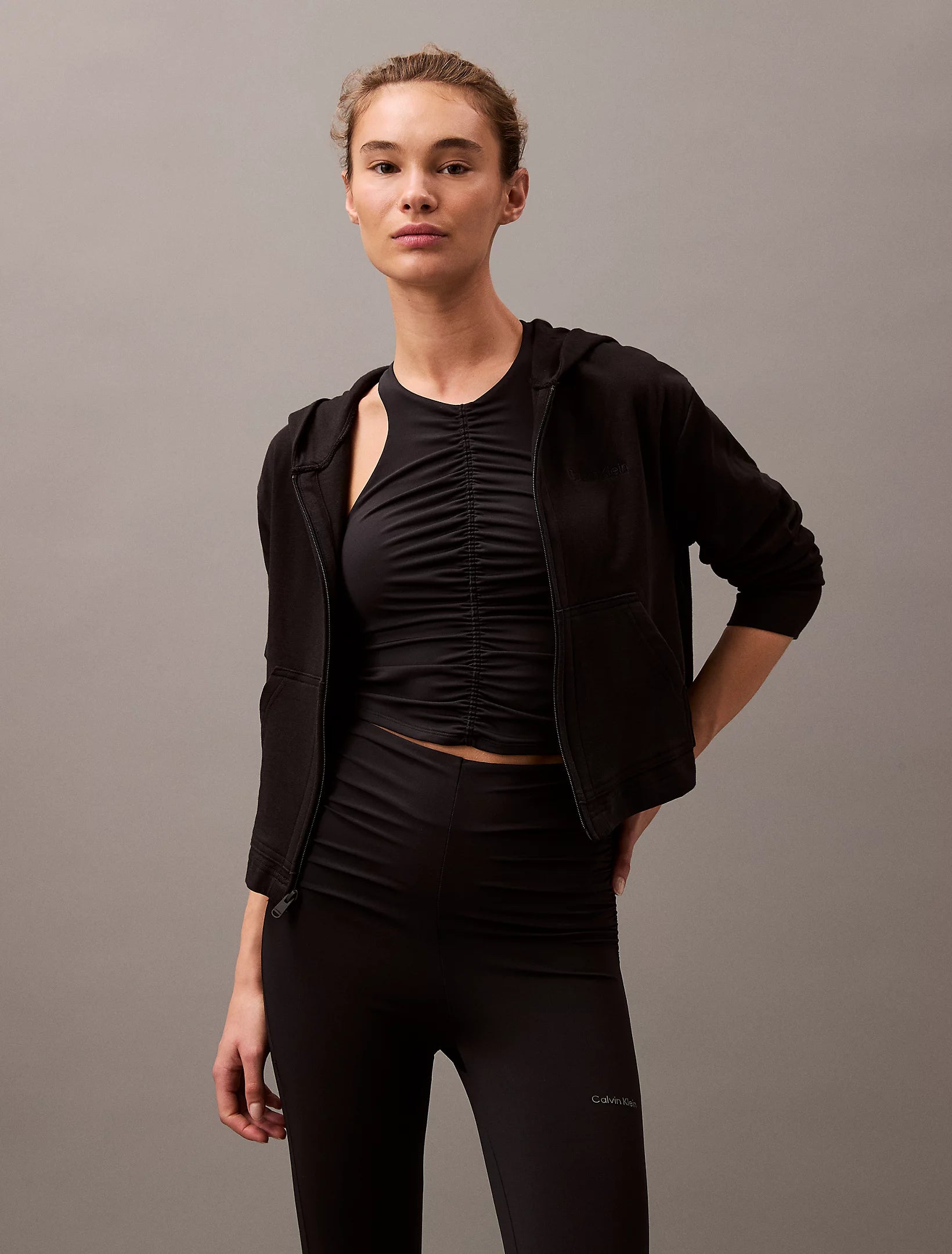 Calvin Klein MODERN TERRY Womens Full Zip Hoodie Black front view with model wearing it styled with black leggings.