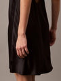 Calvin Klein CK INSTINCT Satin Night Dress Chemise Black side view showcasing the flared hem and smooth satin fabric.