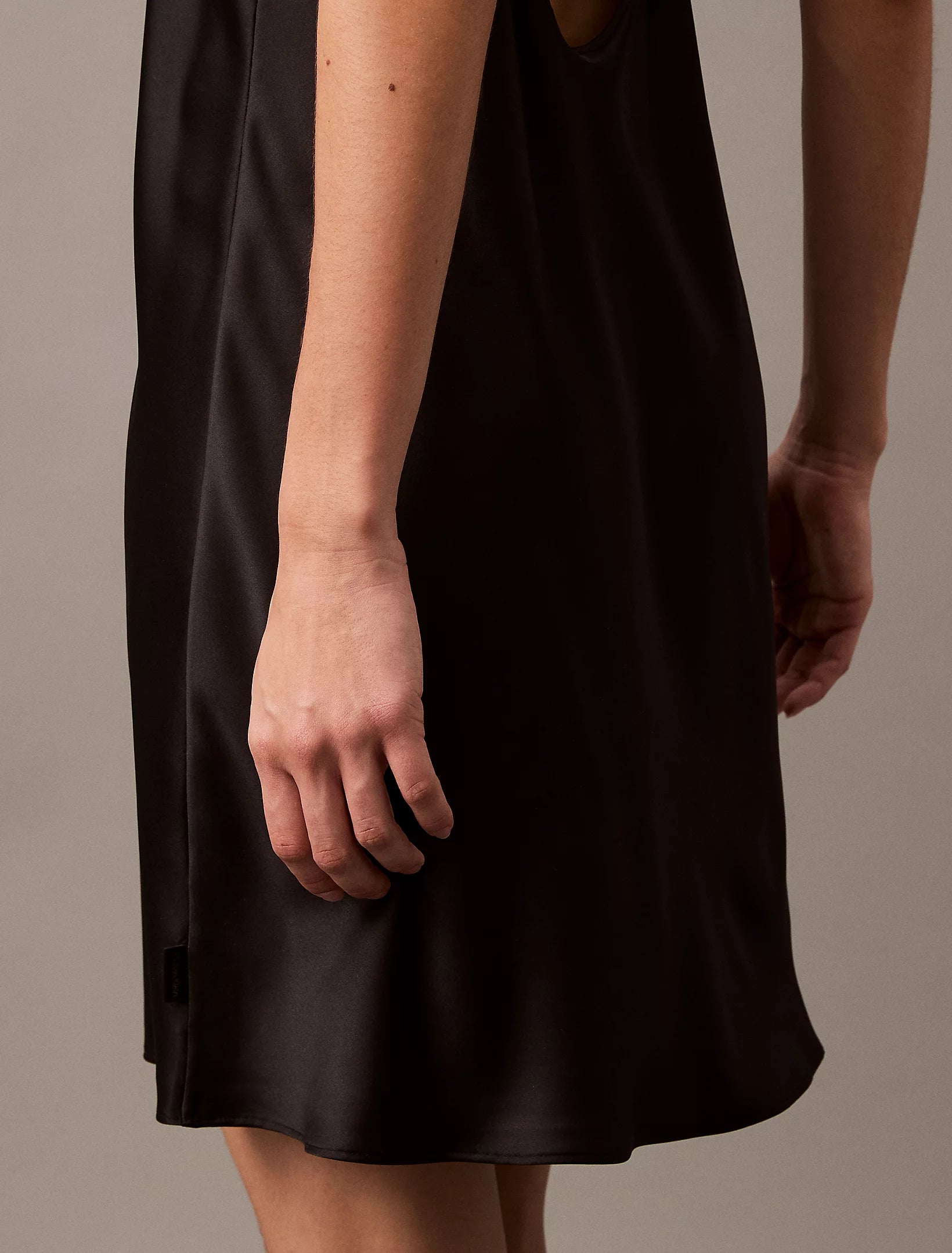 Calvin Klein CK INSTINCT Satin Night Dress Chemise Black side view showcasing the flared hem and smooth satin fabric.