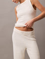 Calvin Klein PLUSH SWEATER Womens Pants Ivory front view showcasing soft fabric and relaxed fit design.