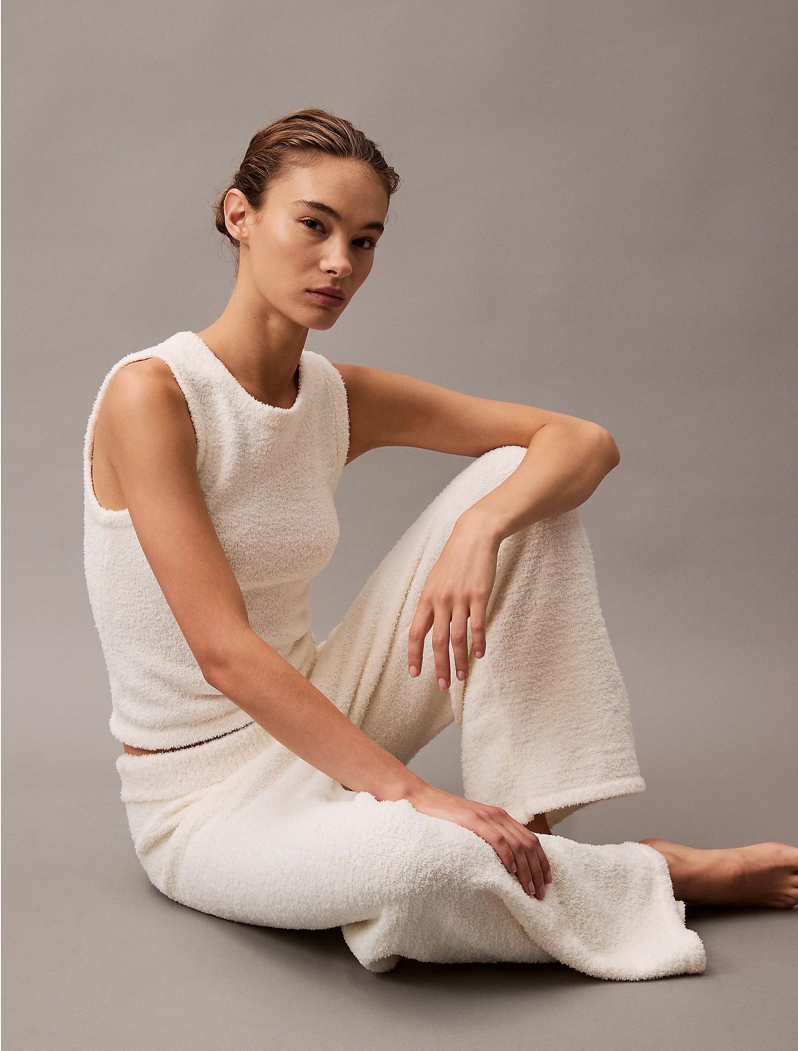 Calvin Klein PLUSH SWEATER Womens Pants Ivory side view on model, showcasing relaxed fit and cozy texture.