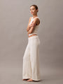 Calvin Klein PLUSH SWEATER Womens Pants Ivory side view featuring relaxed fit and soft texture, perfect for loungewear.