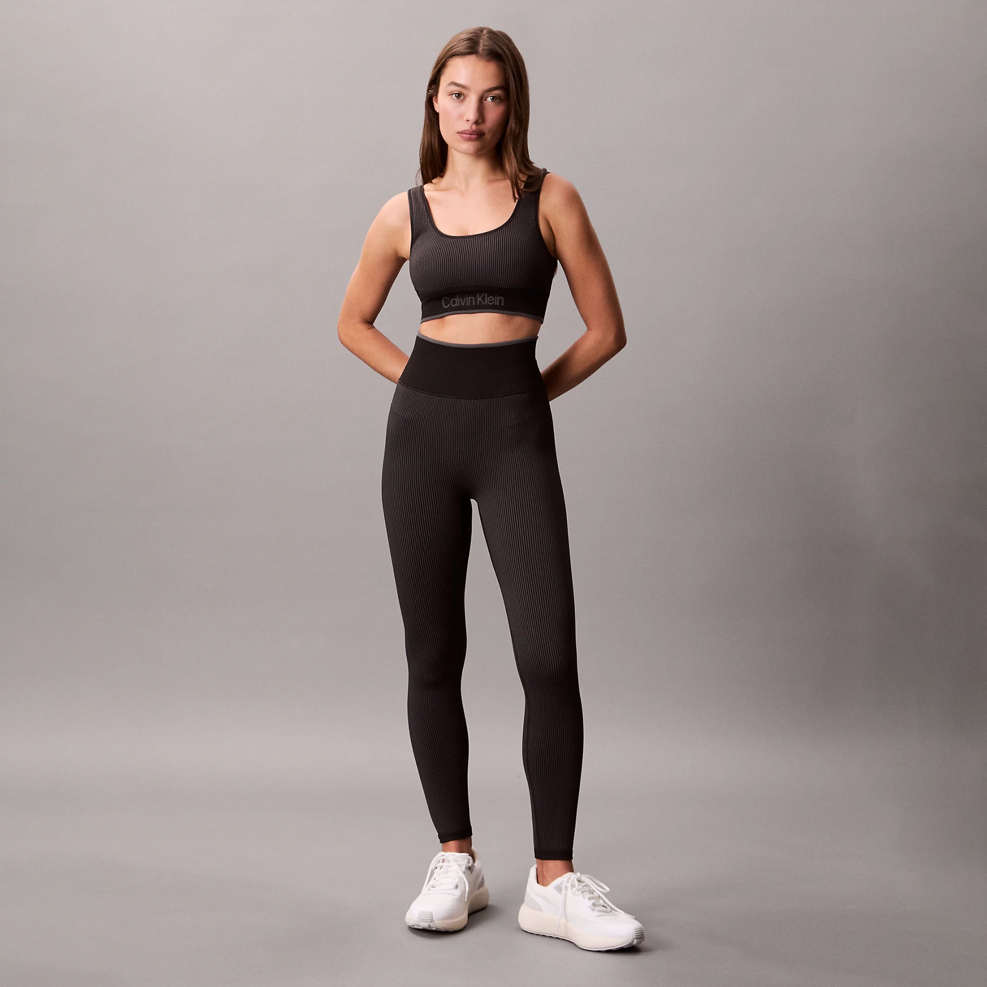 Calvin Klein Medium Impact Sports Bra front view in black, showcasing a stylish design with matching leggings.