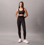 Calvin Klein Medium Impact Sports Bra front view in black, showcasing a stylish design with matching leggings.