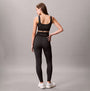 Calvin Klein Medium Impact Sports Bra back view on model, black color, showing pull-on design and snug fit.