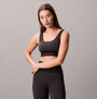 Calvin Klein Medium Impact Sports Bra front view in black, featuring a comfortable pull-on design and regular fit.