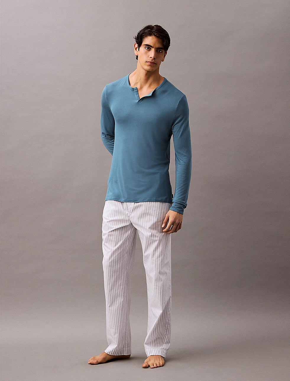 Calvin Klein ULTRA SOFT MODAL Mens Pyjama Top Deck Gray front view on model wearing long sleeve top and striped pants.