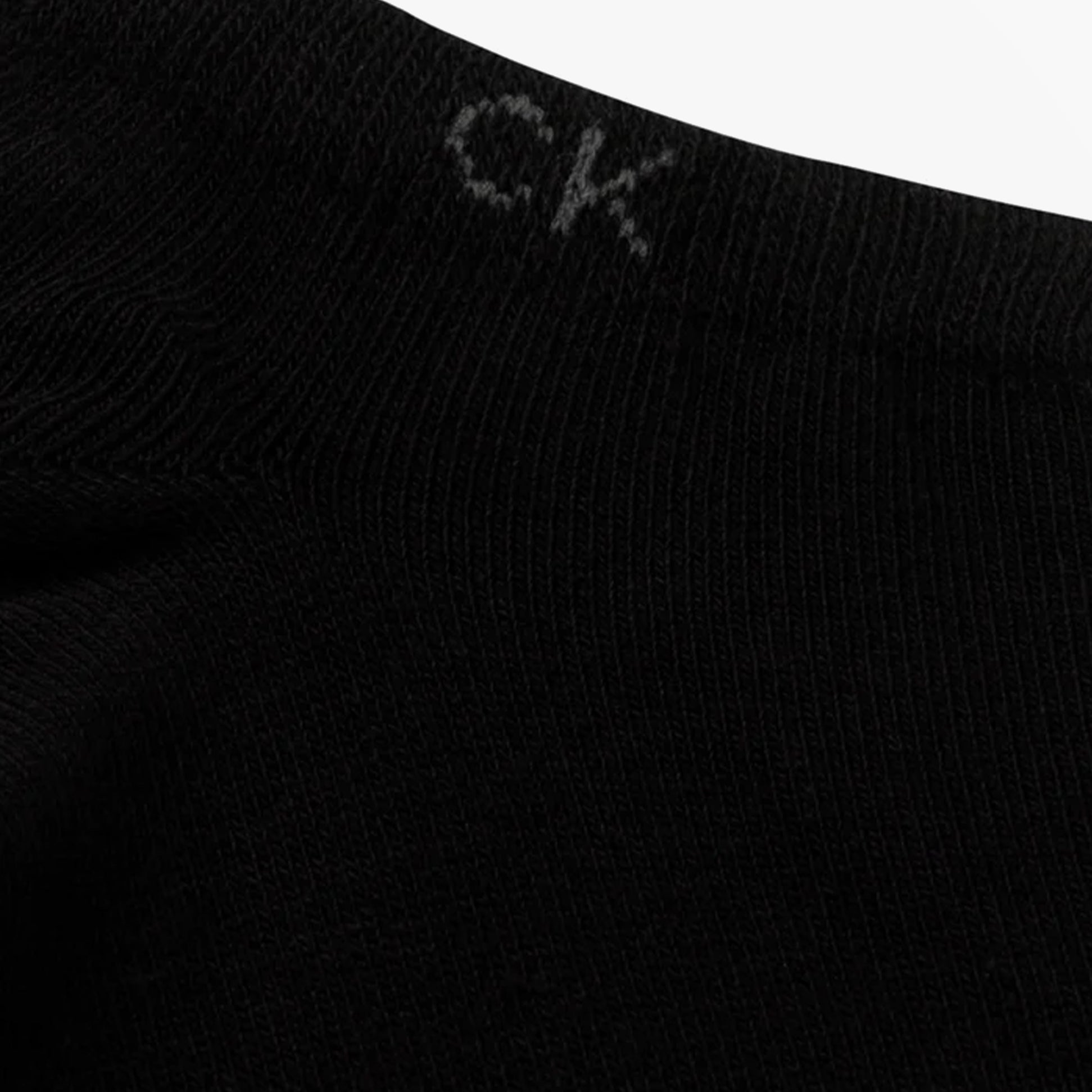 Calvin Klein 2 Pack Mens Ankle Trainer Socks Black detail view showing CK logo at the top of the black sock.