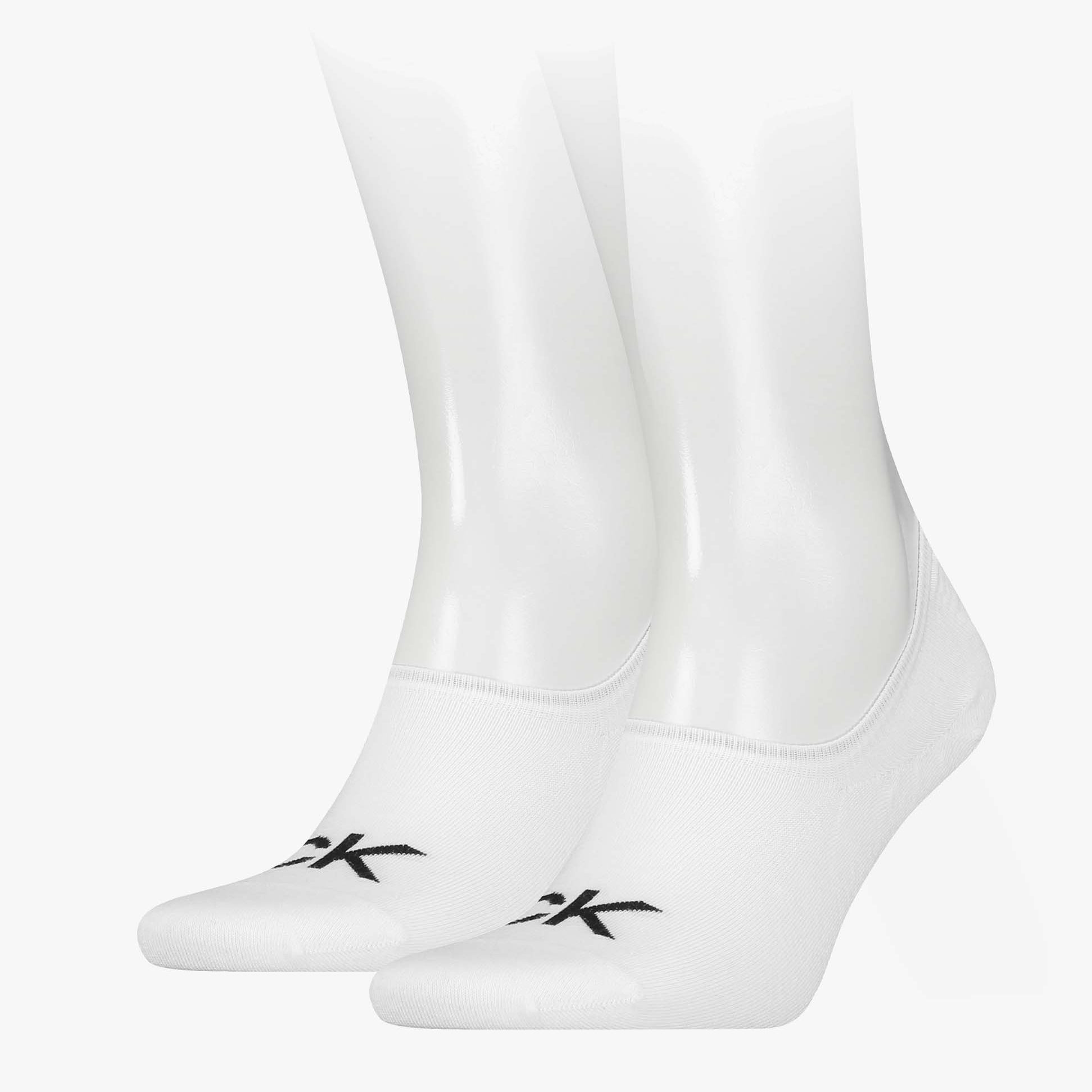 Calvin Klein 2 Pack Logo Mens Invisible Socks White displayed on mannequin feet, showcasing logo and sock design.