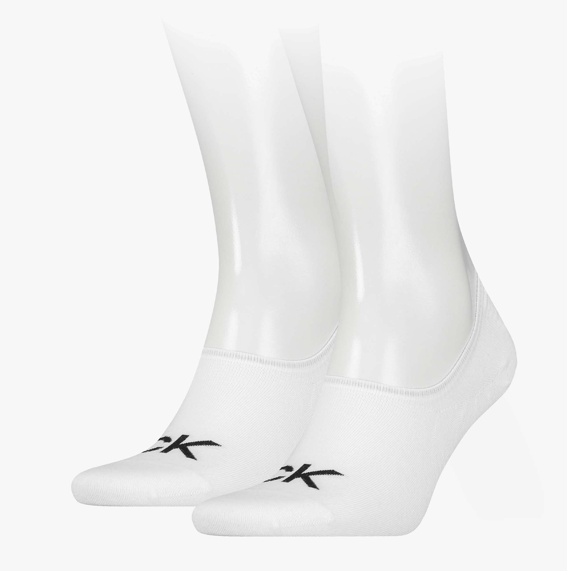 Calvin Klein 2 Pack Logo Mens Invisible Socks White displayed on mannequin feet, showcasing logo and sock design.